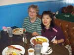 Peggy and Fang enjoy their meals.
